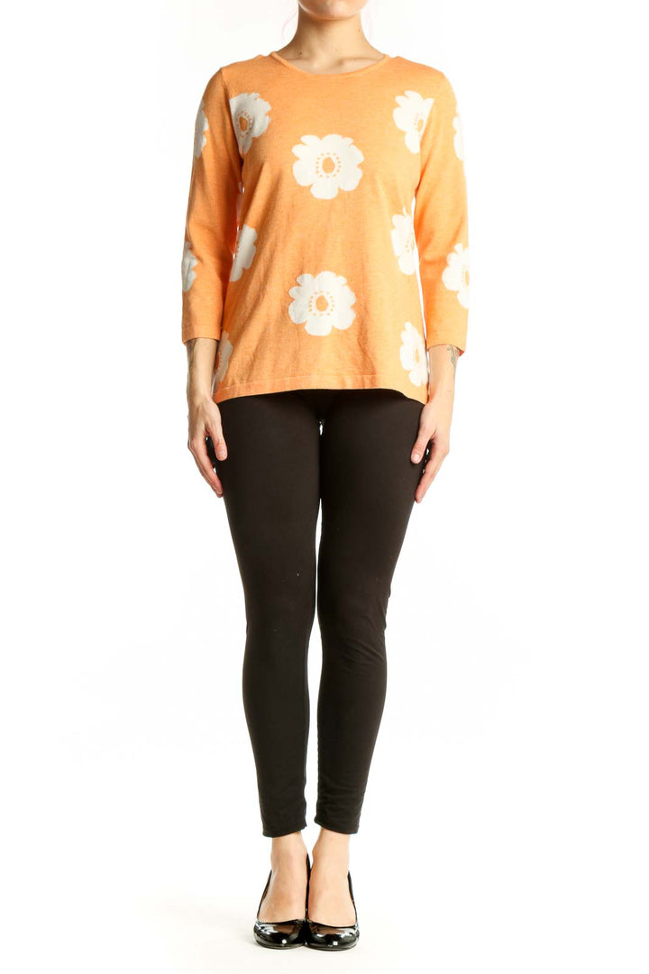 Orange floral print top with white daisy pattern, three-quarter sleeves, crew neckline, front view on model
