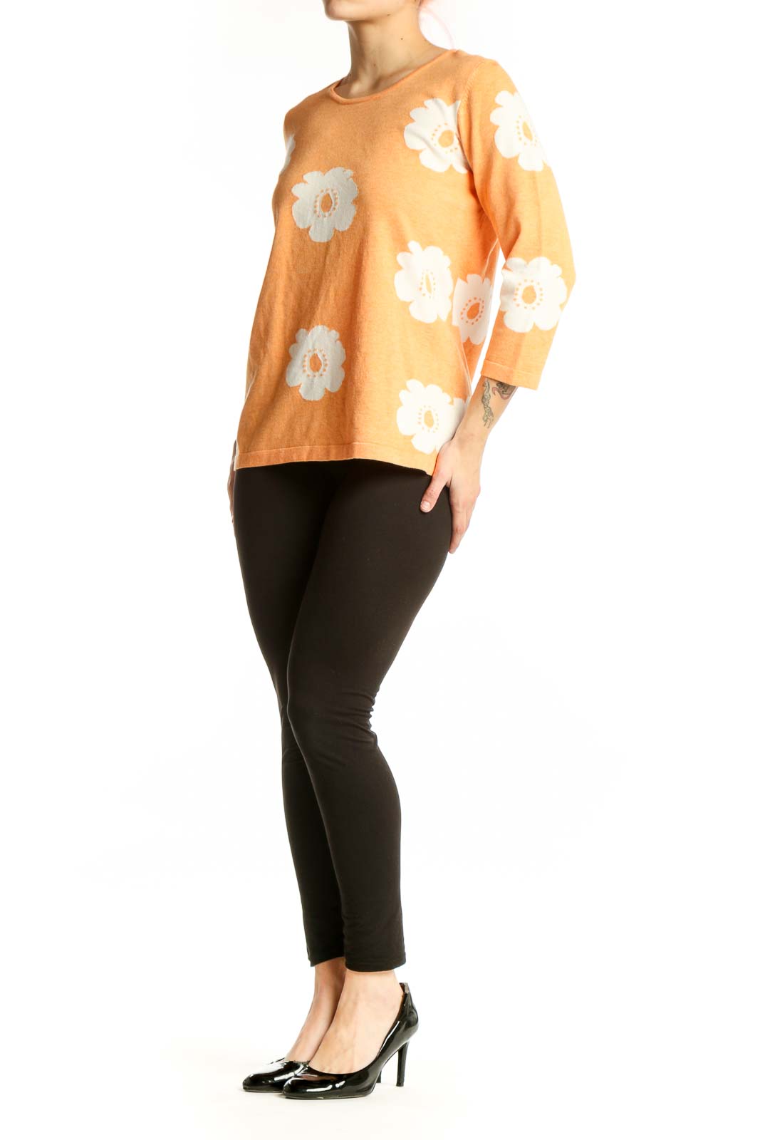Orange floral print top with white daisy pattern, three-quarter sleeves, crew neckline, front view on model