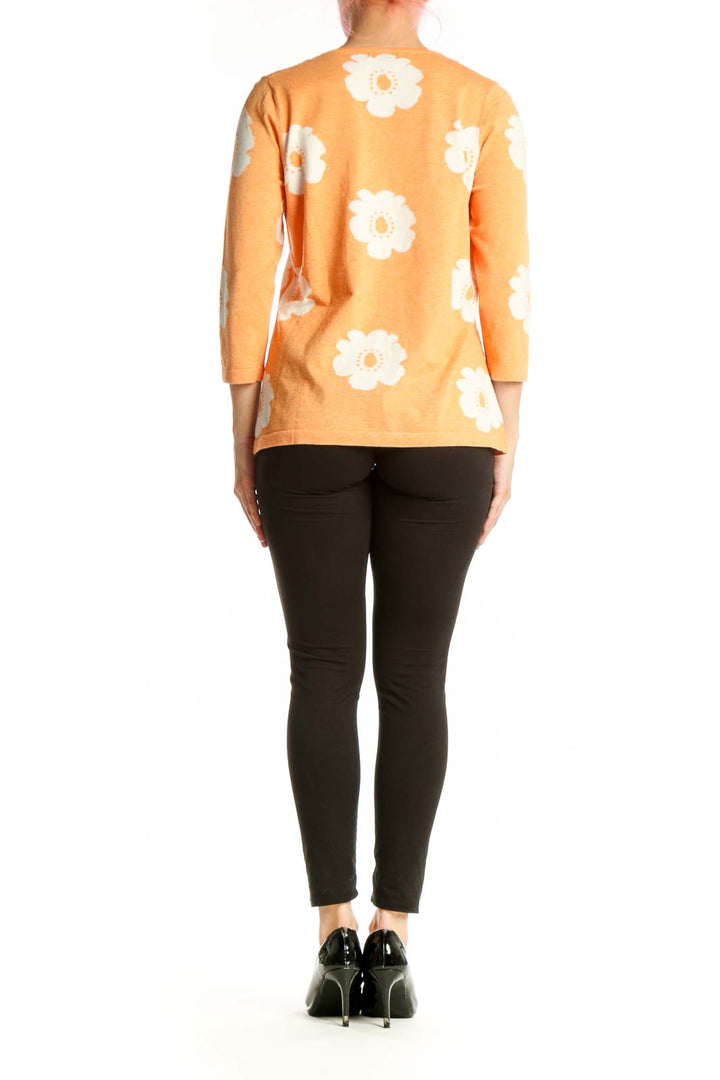Orange floral print top back view showing daisy pattern distribution, three-quarter sleeves, relaxed fit silhouette
