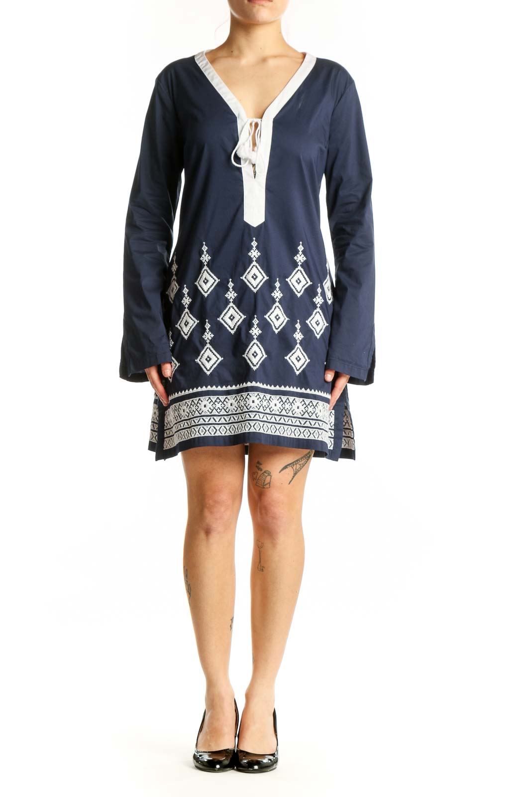 Navy geometric embroidered tunic dress with white tie V-neckline and diamond pattern details