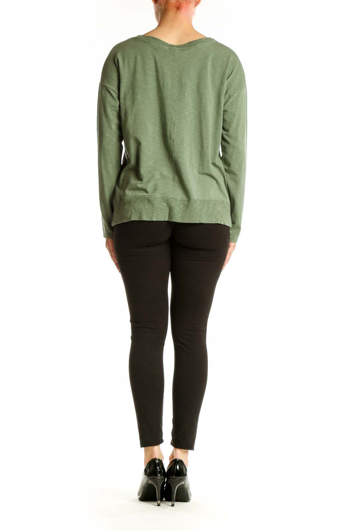 Green V-neck long sleeve top back view, showing relaxed silhouette and hem detail