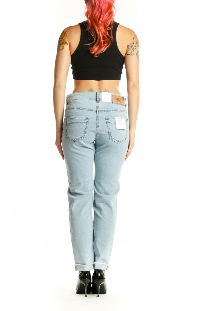 Light blue floral printed denim jeans back view showing botanical pattern and rolled cuff detail