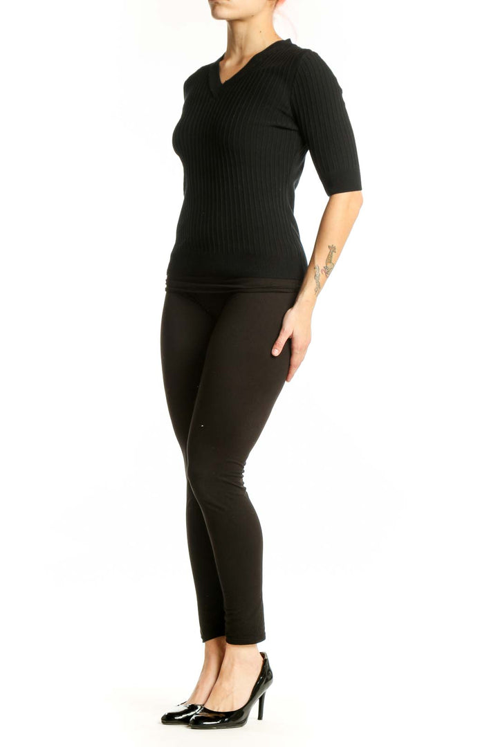 Black ribbed V-neck half sleeve top by Elie Tahari, front view on model