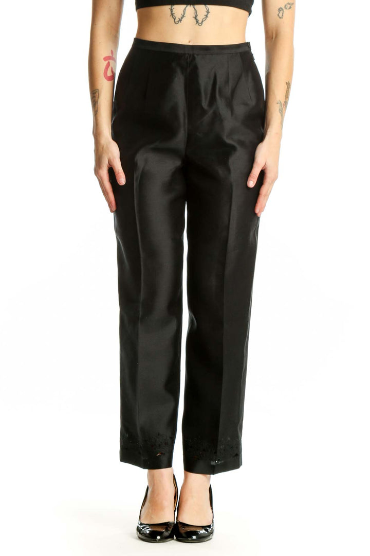 Front view of black silk polyester dress pants with high-waisted silhouette and straight-leg cut