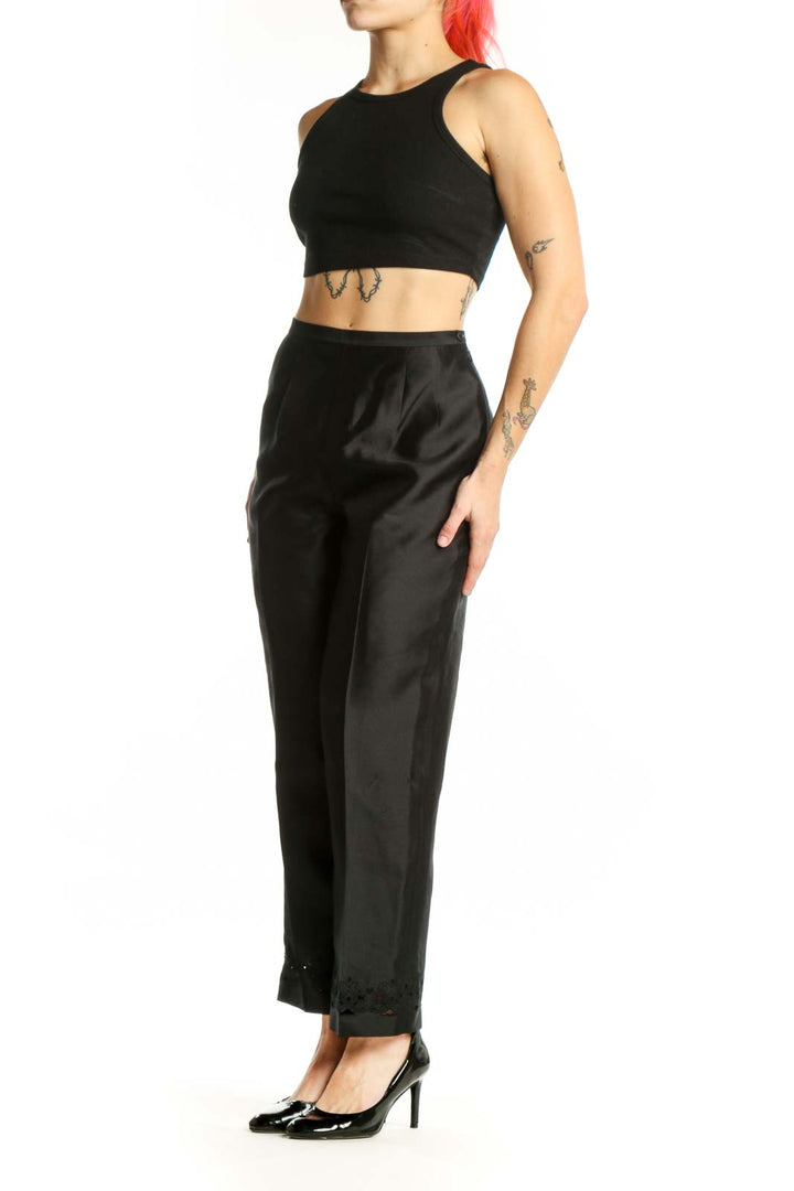 Front view of black silk polyester dress pants with high-waisted silhouette and straight-leg cut