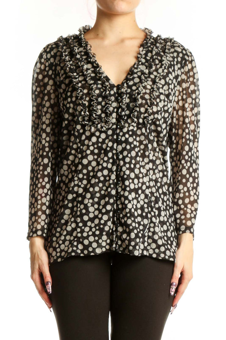 Black and white polka dot blouse with ruffle V-neckline and long sleeves, front view