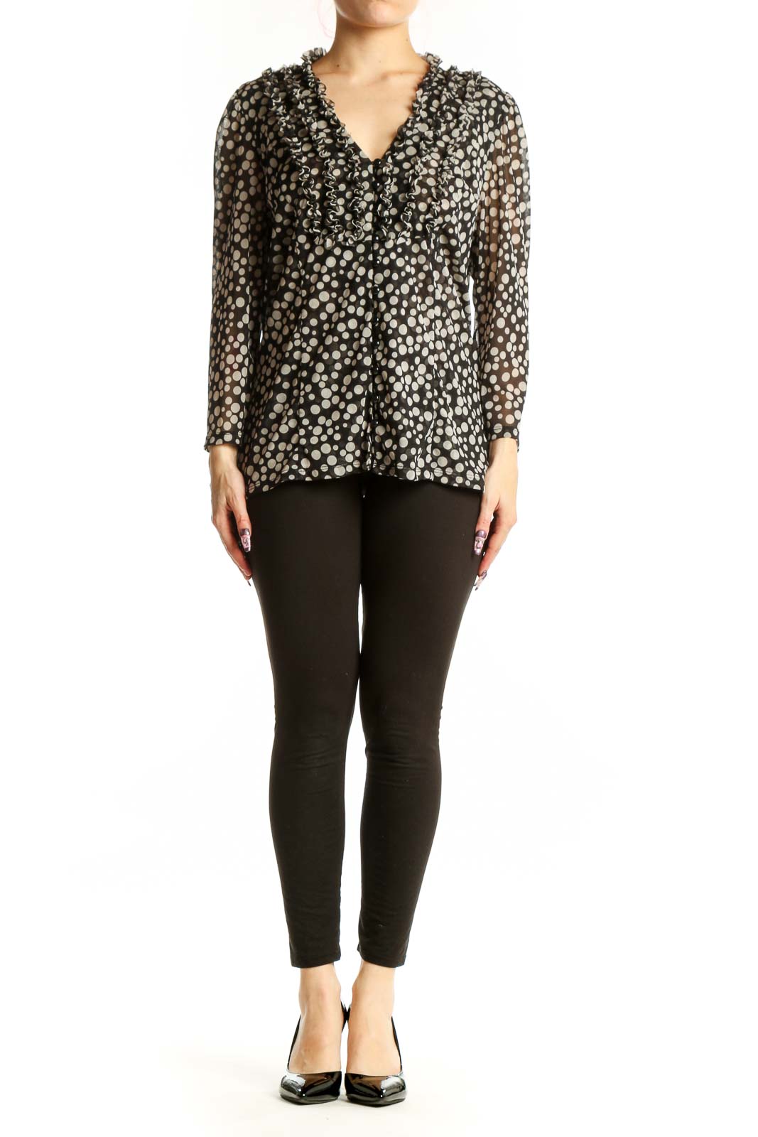 Black and white polka dot blouse with ruffle V-neckline and long sleeves, front view