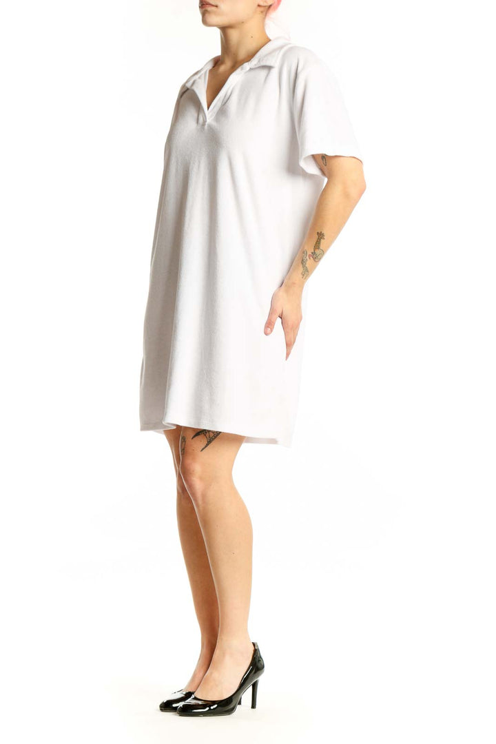 White polo shirt dress with short sleeves and collar, front view on model