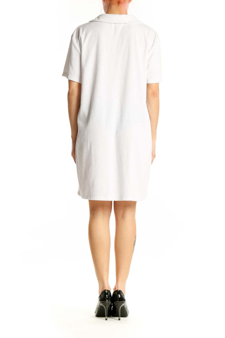 White polo shirt dress back view showing relaxed A-line silhouette and knee-length cut