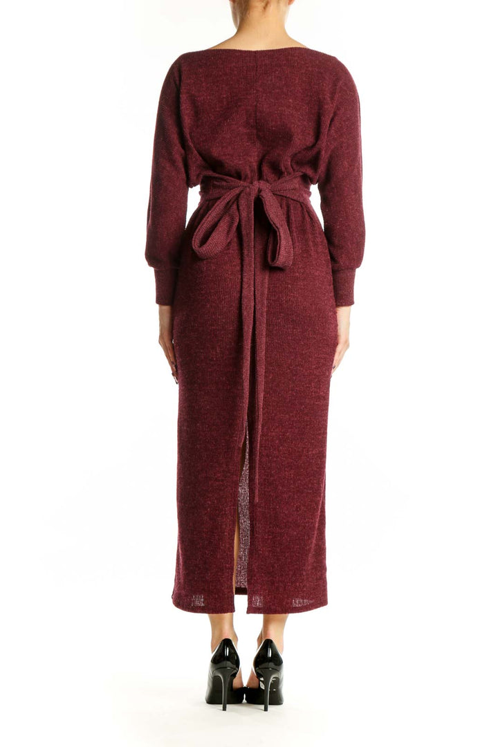 Back view of burgundy long sleeve knit midi dress showing relaxed sleeve drape and midi length