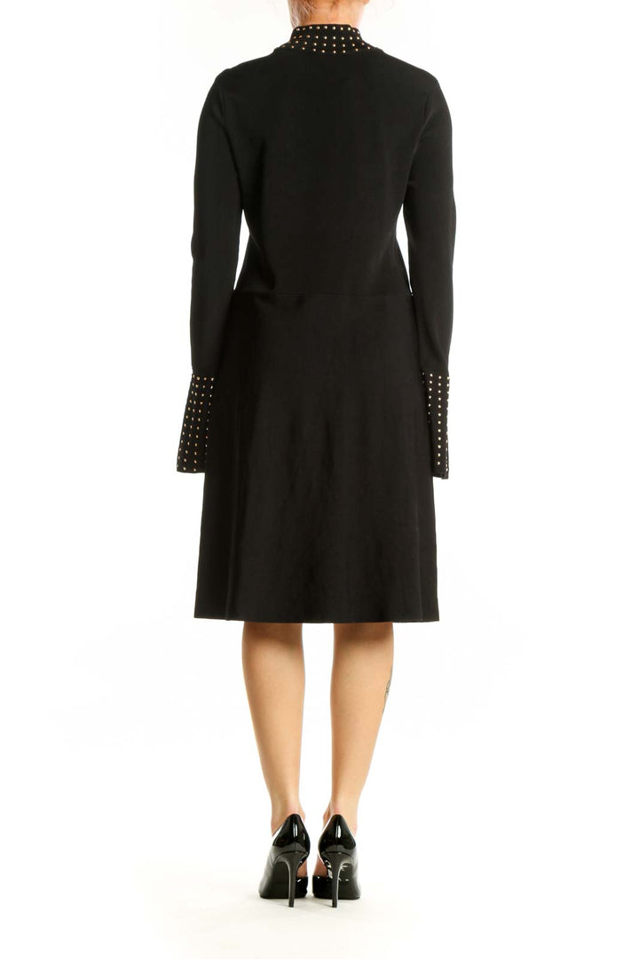 Black studded mock neck midi dress with bell cuffs, back view