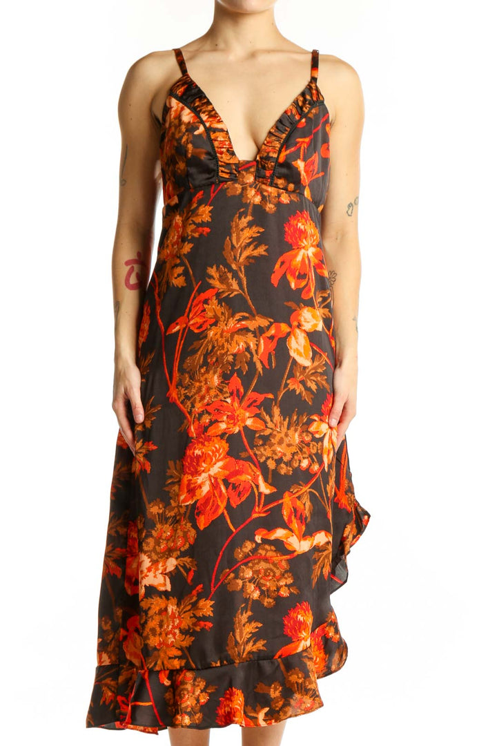 Black floral midi dress with orange and red blooms, ruffled V-neckline, and cascading ruffle hem - front view