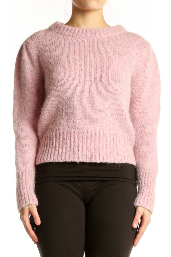 Pink cropped knit pullover sweater with crew neck and long sleeves, front view