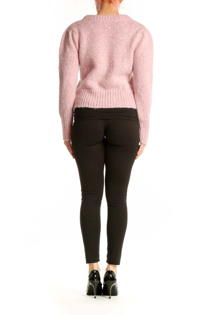 Pink cropped knit pullover sweater with crew neck and long sleeves, back view