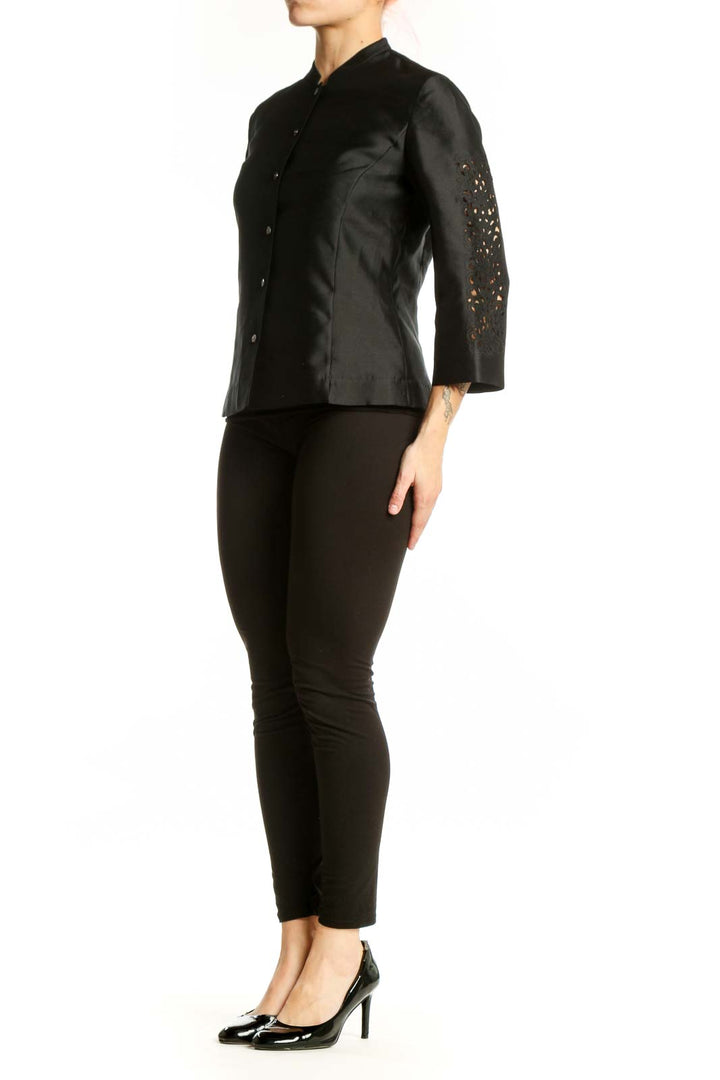 Black silk button-front jacket with mandarin collar and metallic buttons, front view