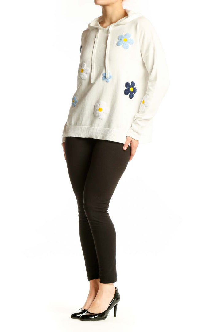Cream cotton hoodie with colorful embroidered floral daisy design on front and sleeves