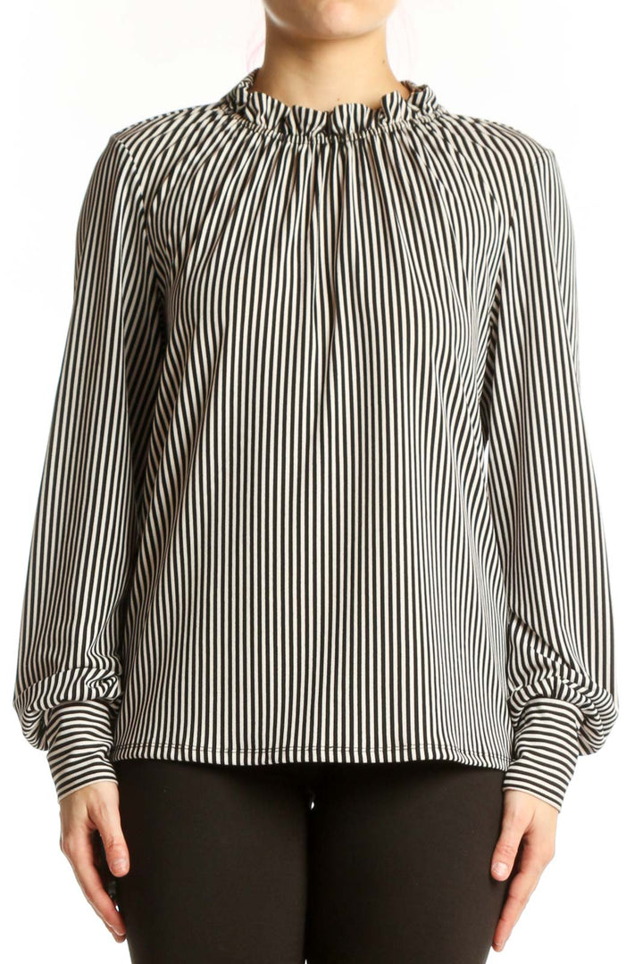Black and white vertical striped blouse with gathered neckline and long voluminous sleeves