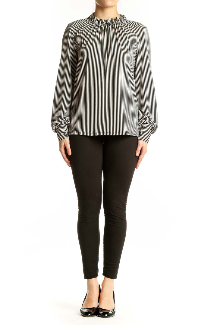 Black and white vertical striped blouse with gathered neckline and long voluminous sleeves