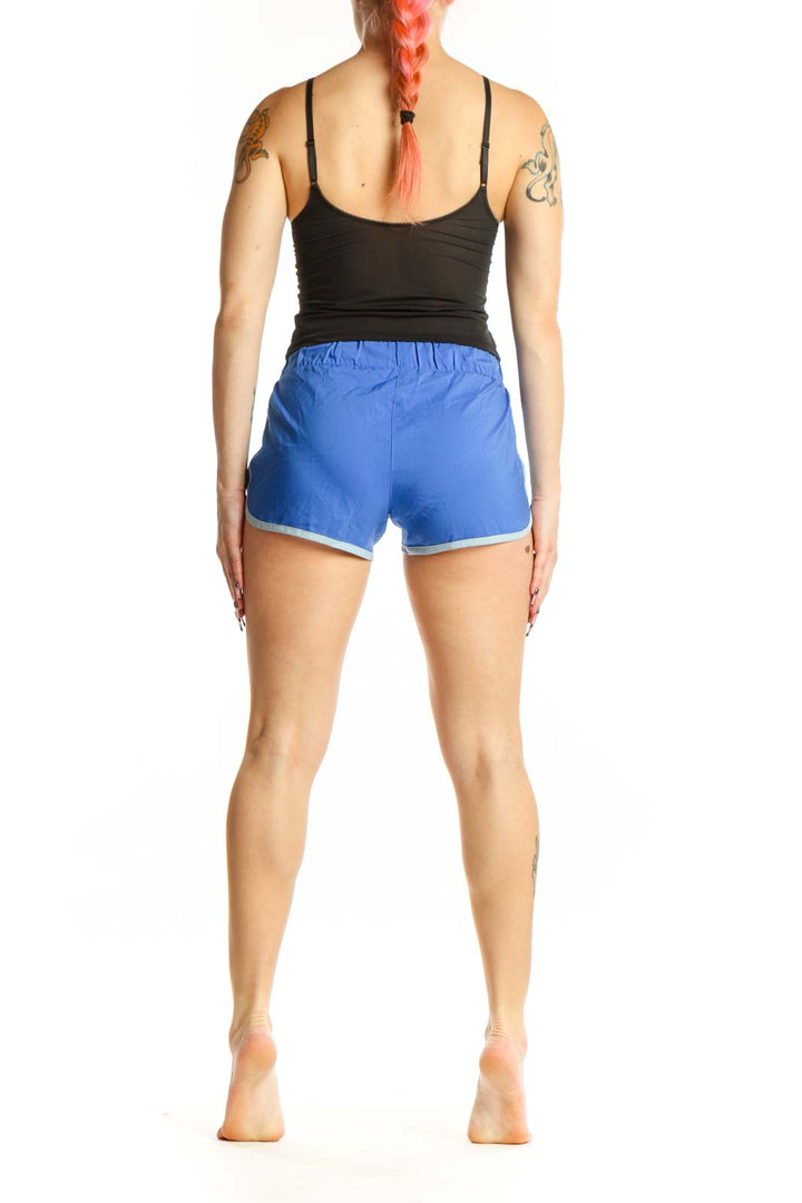 Back view of blue Adidas athletic shorts showing Adidas branding and relaxed fit silhouette