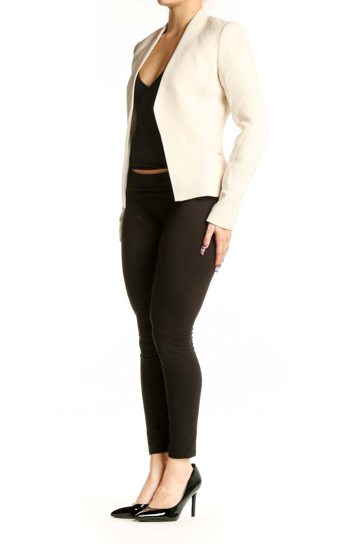 Front view of cream polyester blazer by Calvin Klein, XS size, featuring open-front tailored design and long sleeves