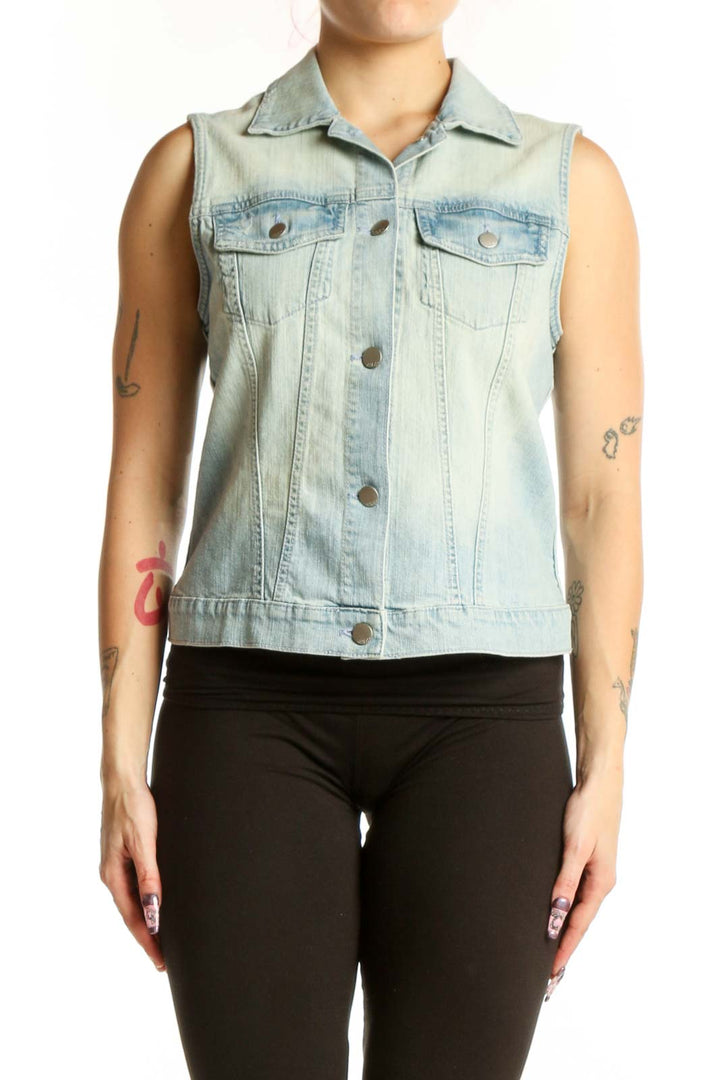 Light blue denim sleeveless vest with button-front closure and chest pockets, worn with black leggings