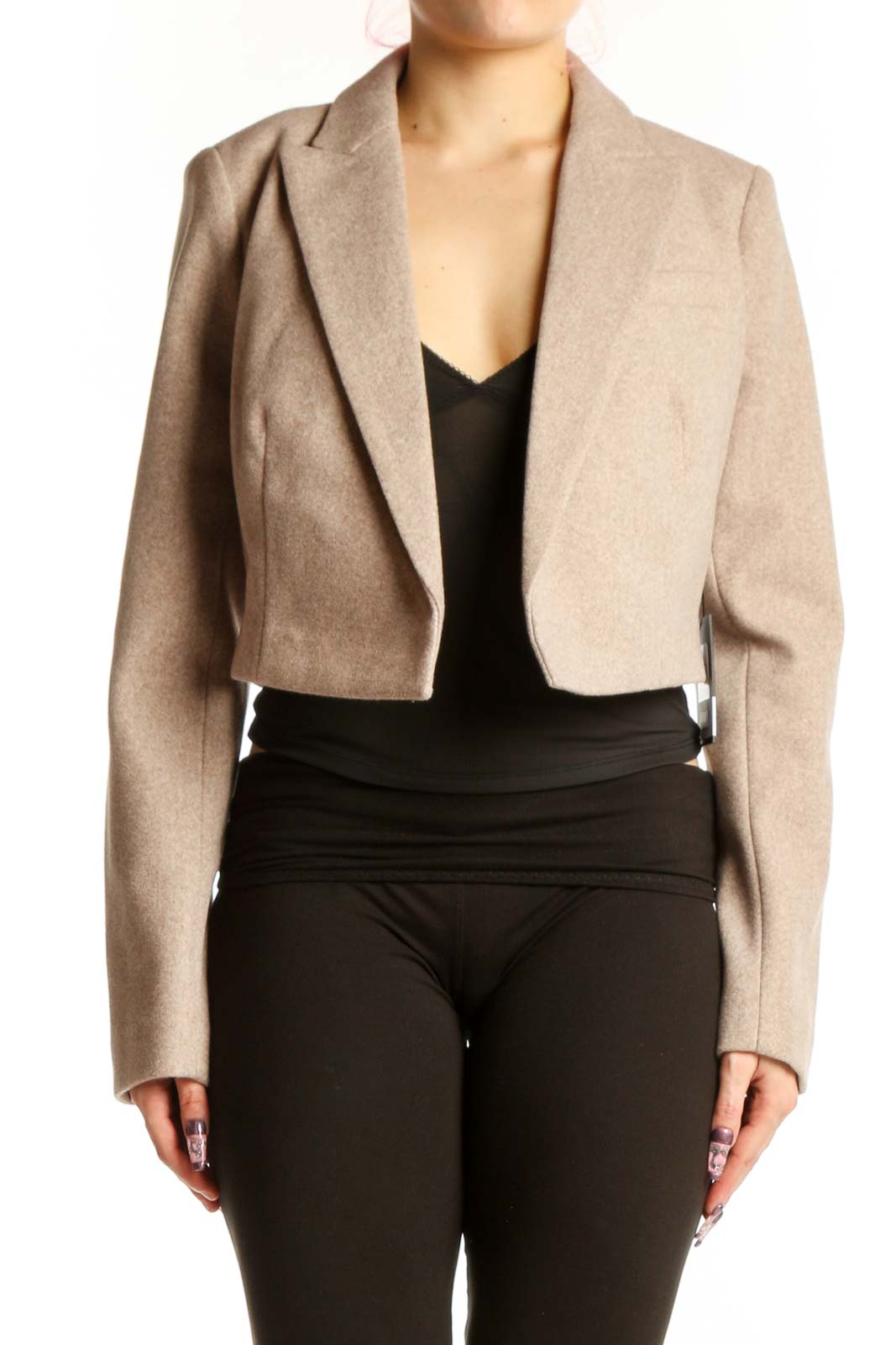DKNY beige cropped blazer jacket with notch lapel worn over black top, front view