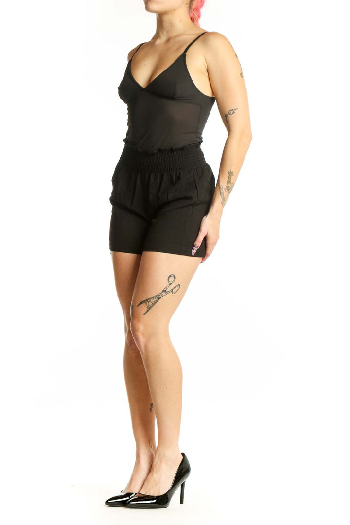 Black paperbag shorts with smocked waistband by Calvin Klein, front view on model