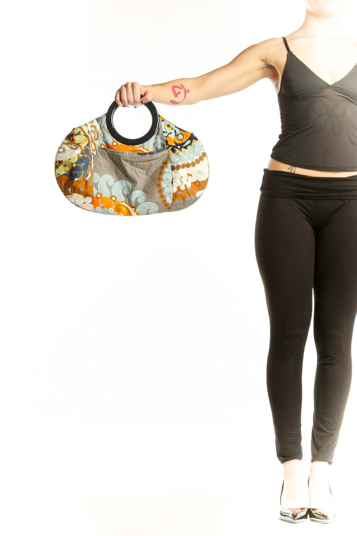 Multicolor floral cotton clutch by J.Crew with black handle, featuring vibrant orange, yellow, navy and cream ornamental print pattern