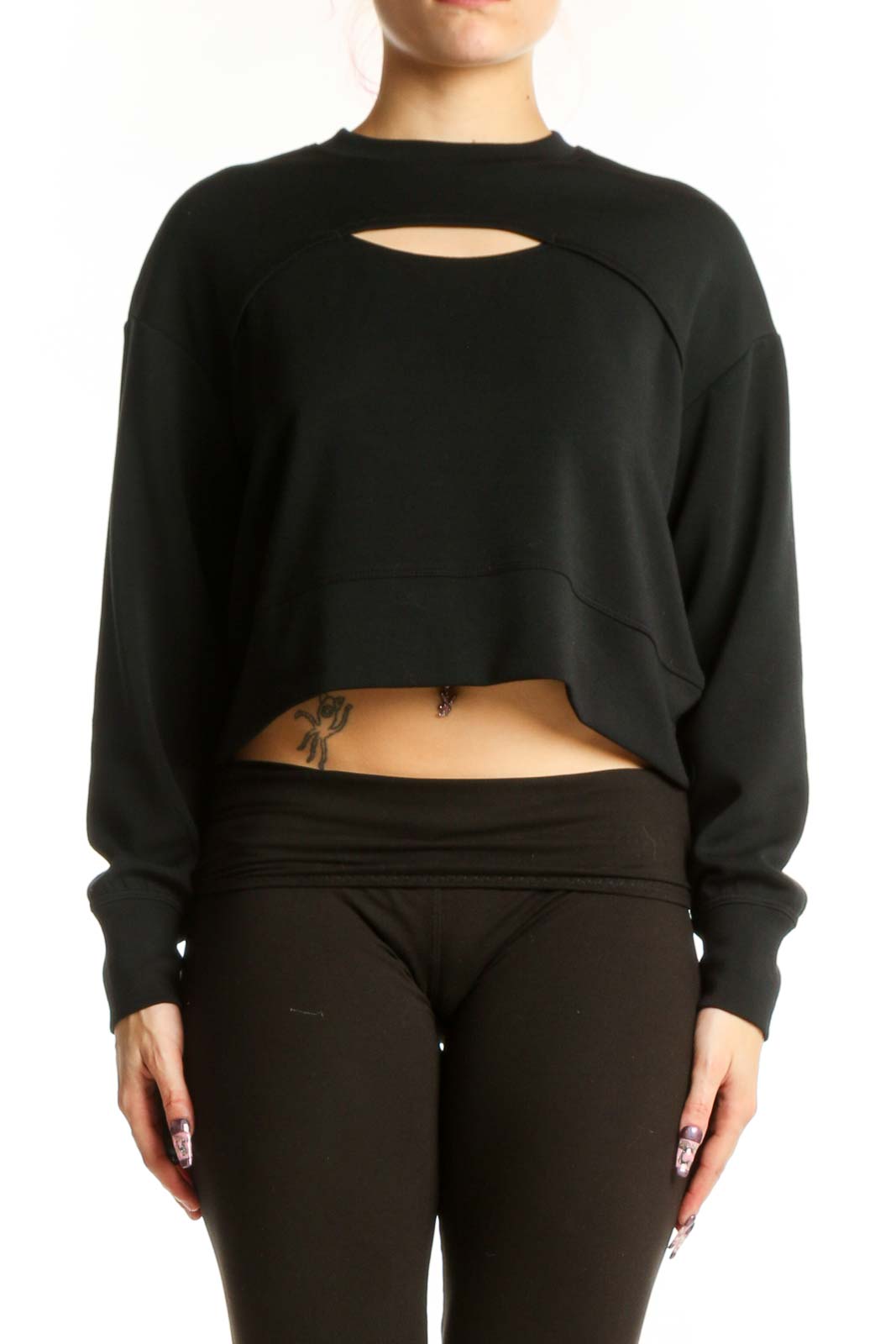 Black cutout crop sweatshirt with front cutout detail, worn with black leggings