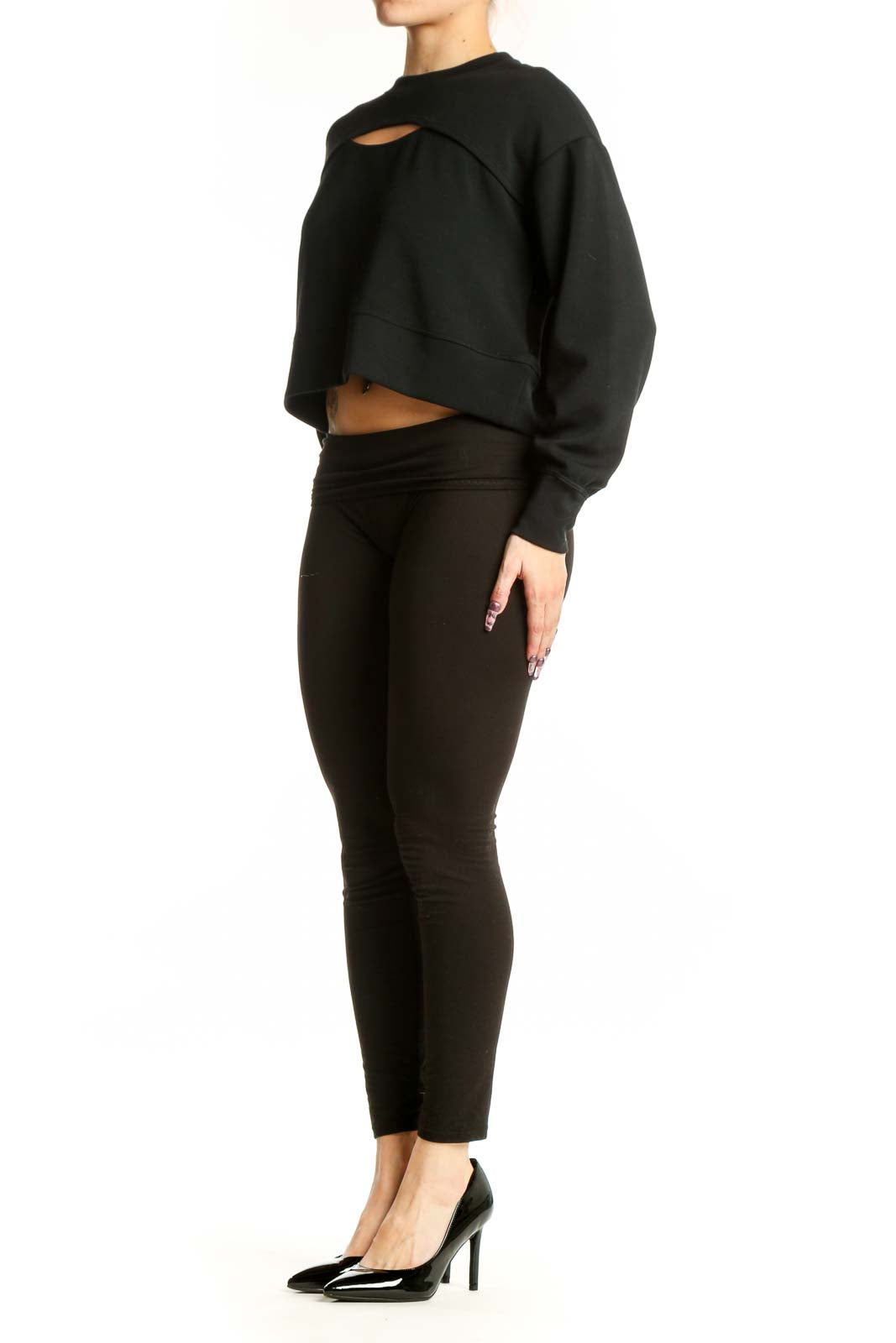 Black cutout crop sweatshirt with front cutout detail, worn with black leggings