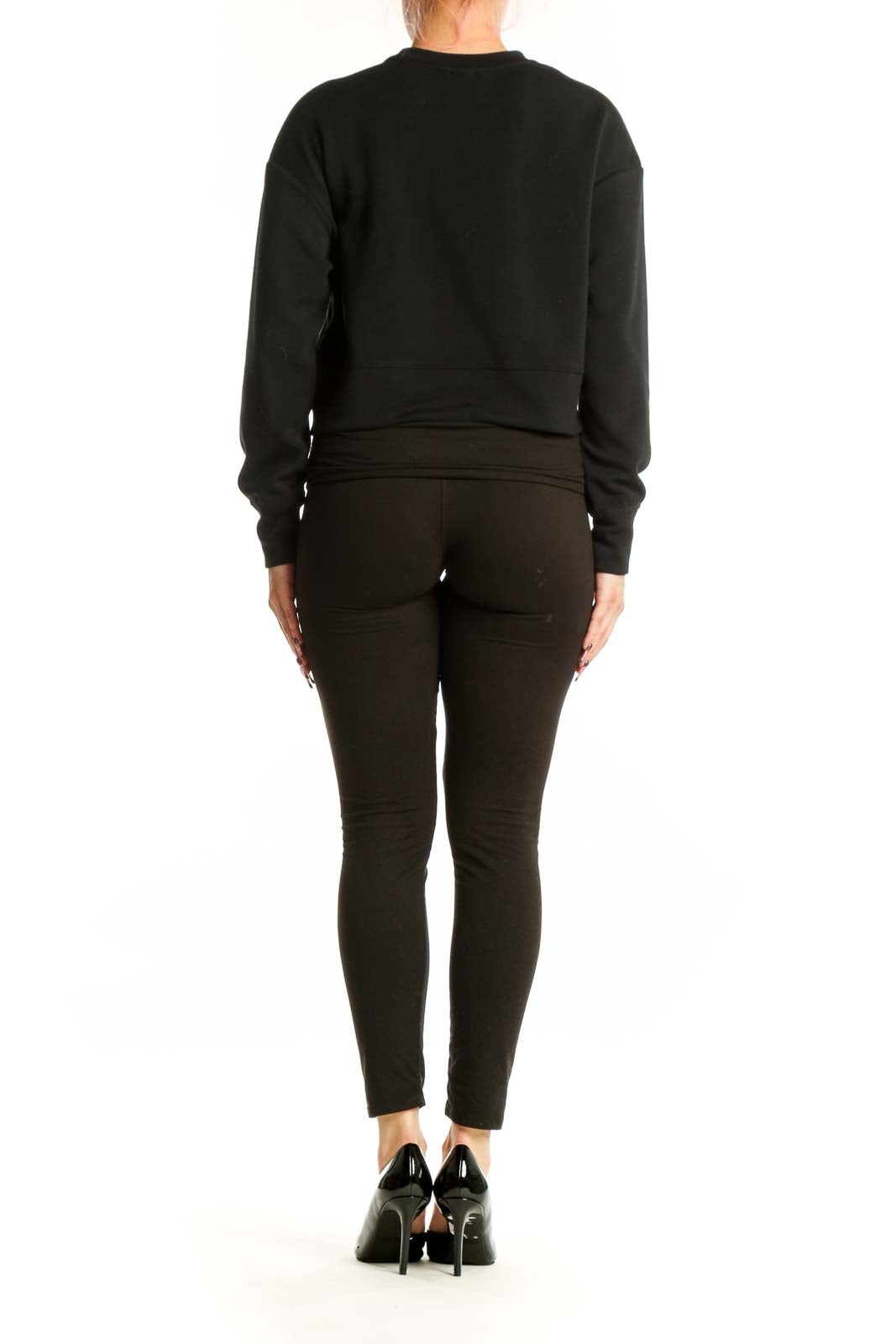 Back view of black crop sweatshirt showing back cutout design and cropped silhouette