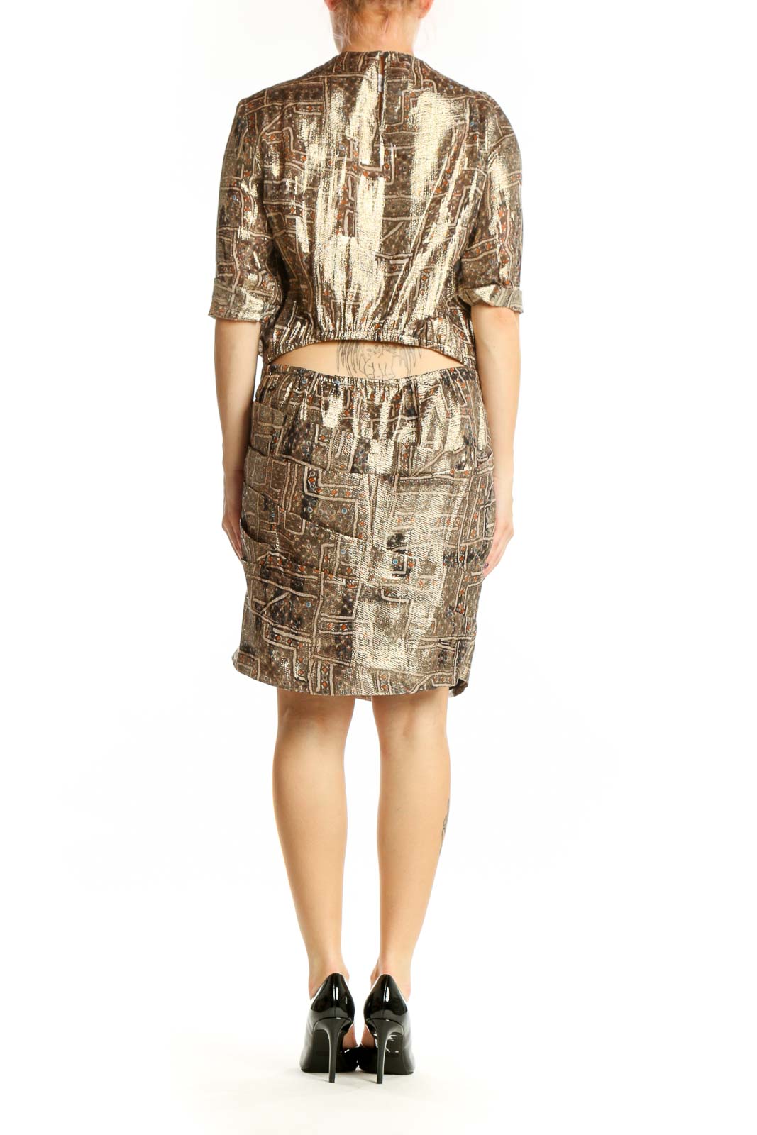 Back view of gold metallic abstract print silk dress showing full abstract pattern and relaxed silhouette