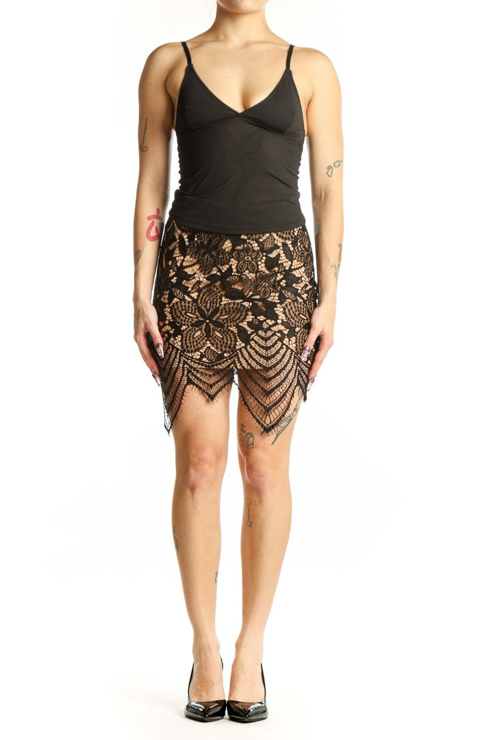 Black lace mini skirt with geometric and floral patterns and scalloped hemline, front view