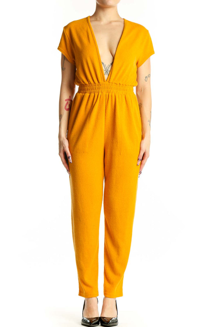 Gold deep V-neck short sleeve jumpsuit with elasticized waist and full-length pants, front view