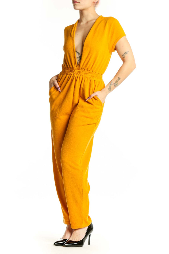 Gold deep V-neck short sleeve jumpsuit with elasticized waist and full-length pants, front view