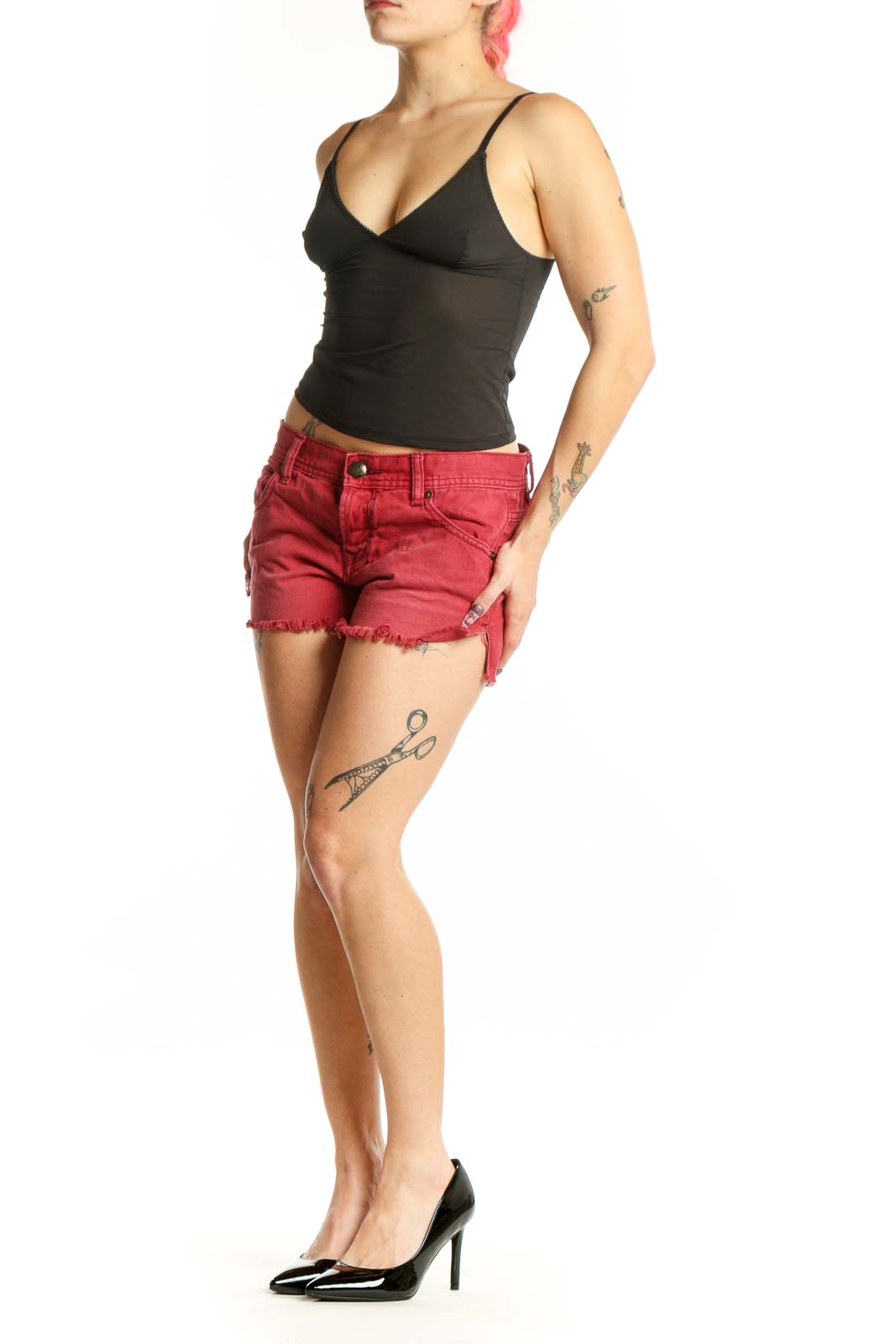 Red distressed cotton denim shorts with frayed hem and five-pocket design, front view