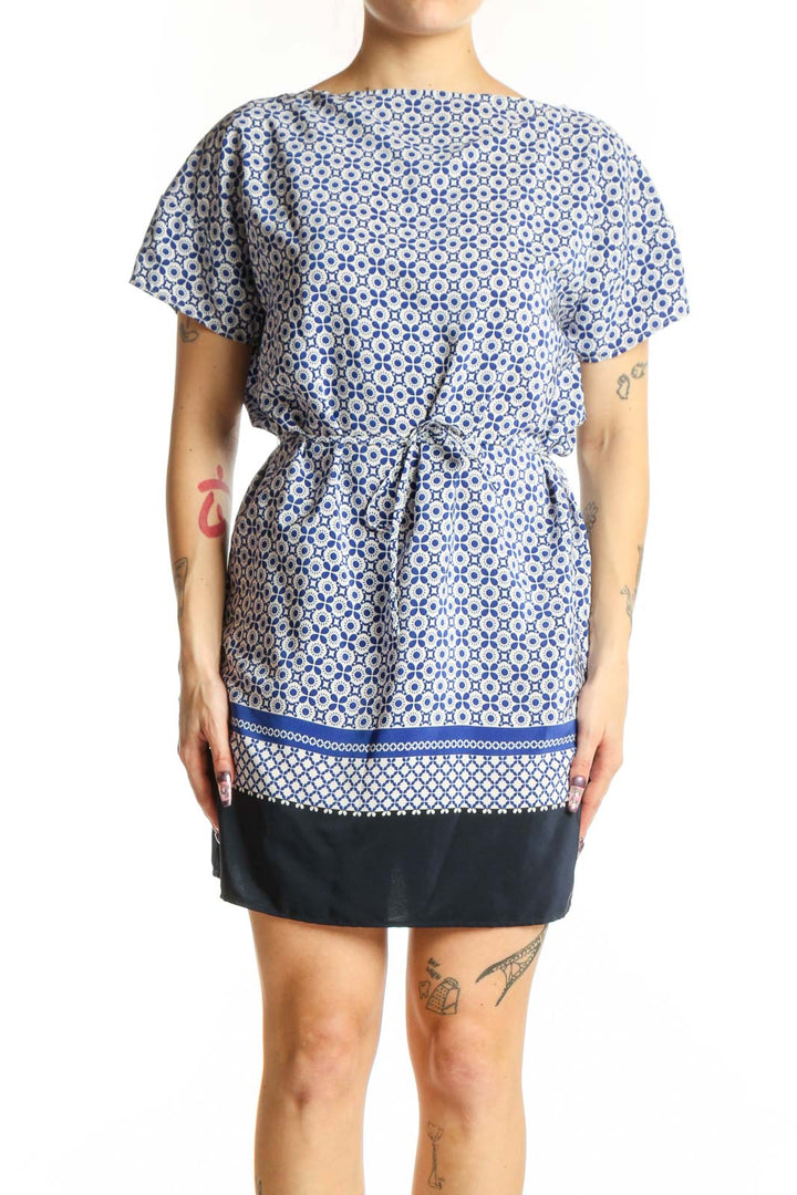 Blue and white geometric print short-sleeve dress with cinched waist and navy trim, front view