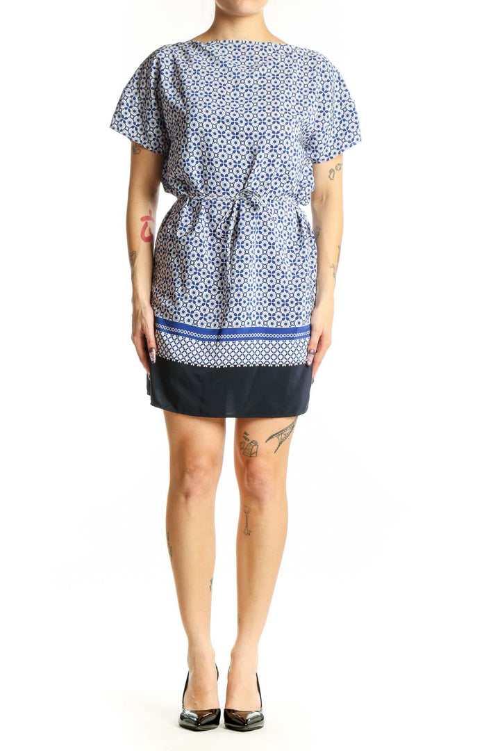 Blue and white geometric print short-sleeve dress with cinched waist and navy trim, front view