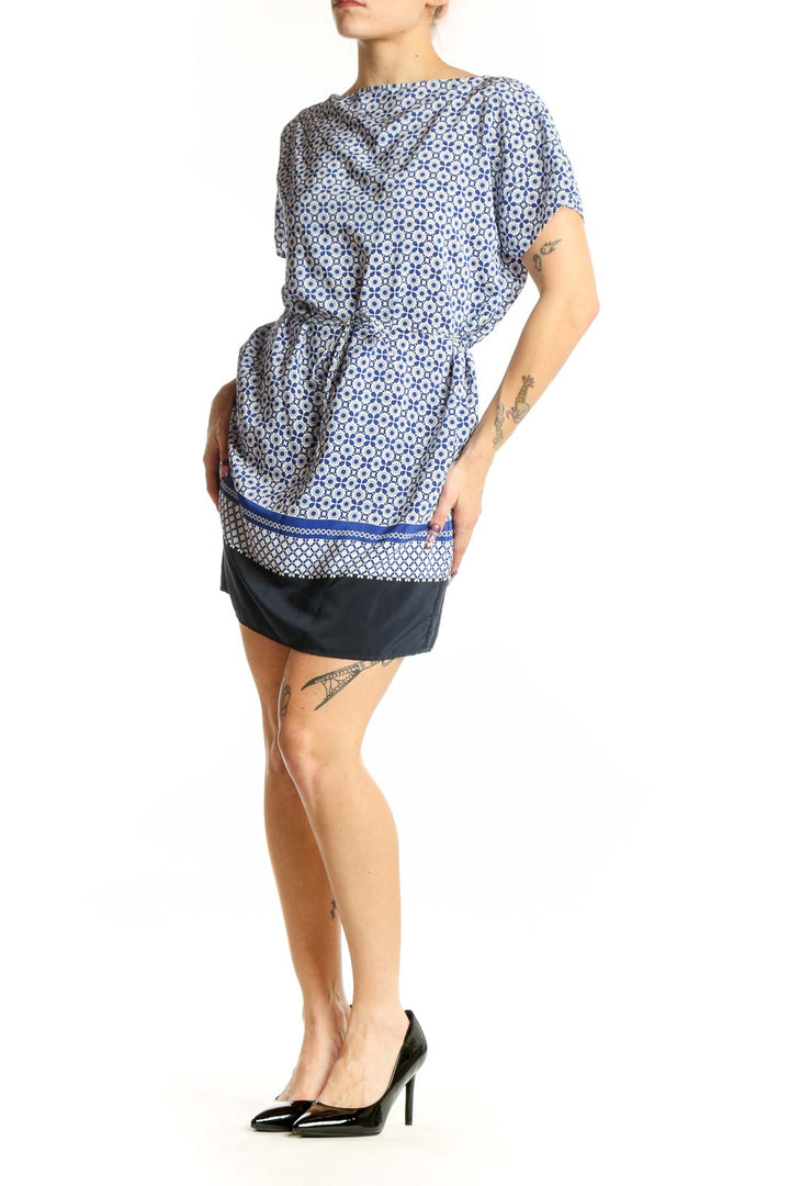 Blue and white geometric print short-sleeve dress with cinched waist and navy trim, front view