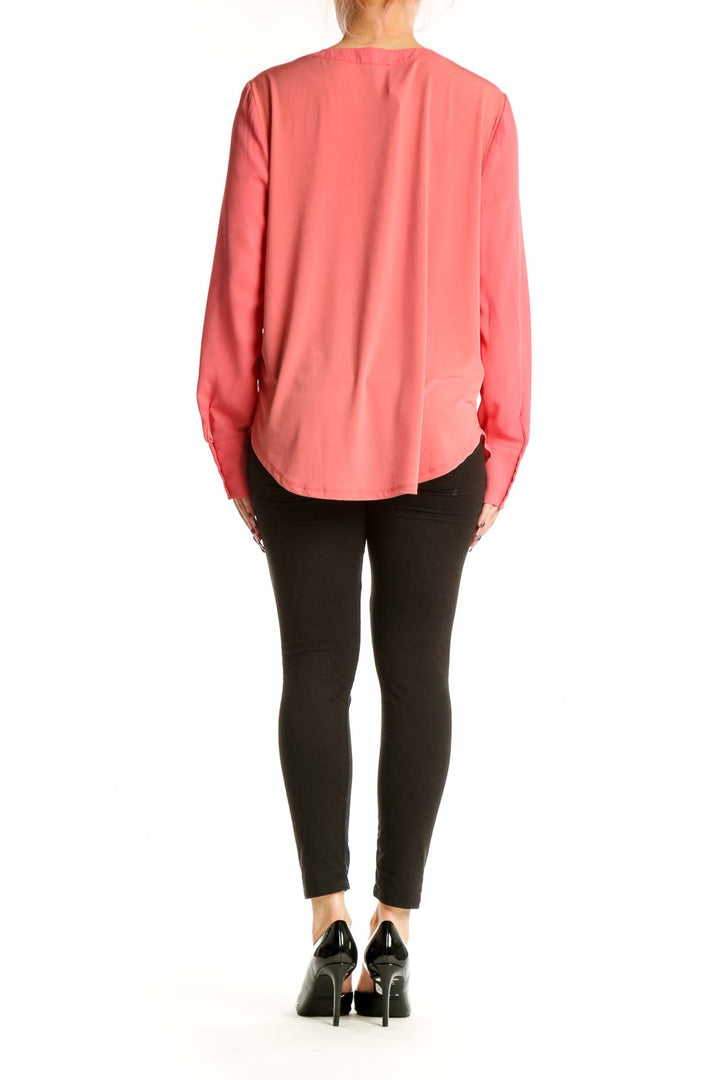 Coral pink V-neck long sleeve blouse by Ann Taylor, back view showing relaxed fit and draping