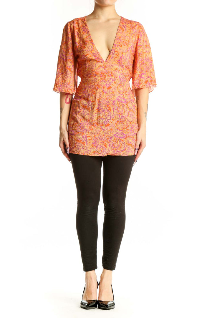 Orange and pink paisley print wrap top with V-neckline and three-quarter sleeves by VIX by Paula Hermanny
