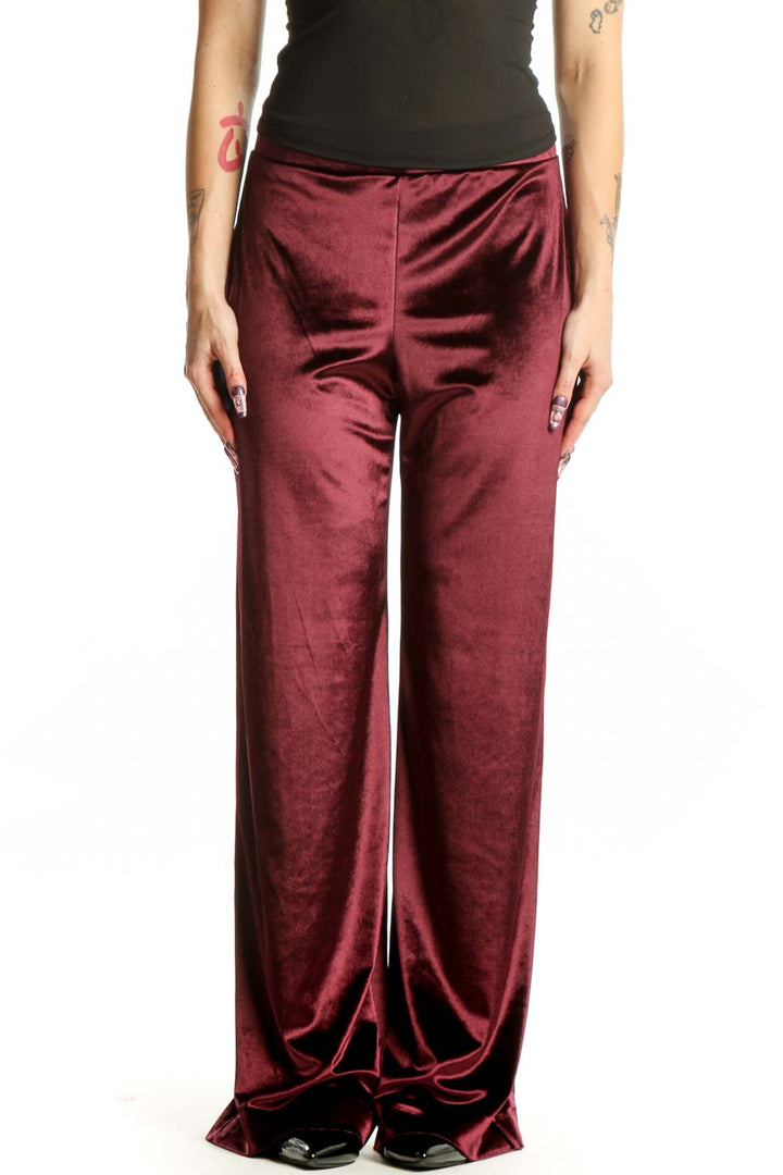 Front view of burgundy velvet wide-leg pants with high waistband and flowing silhouette