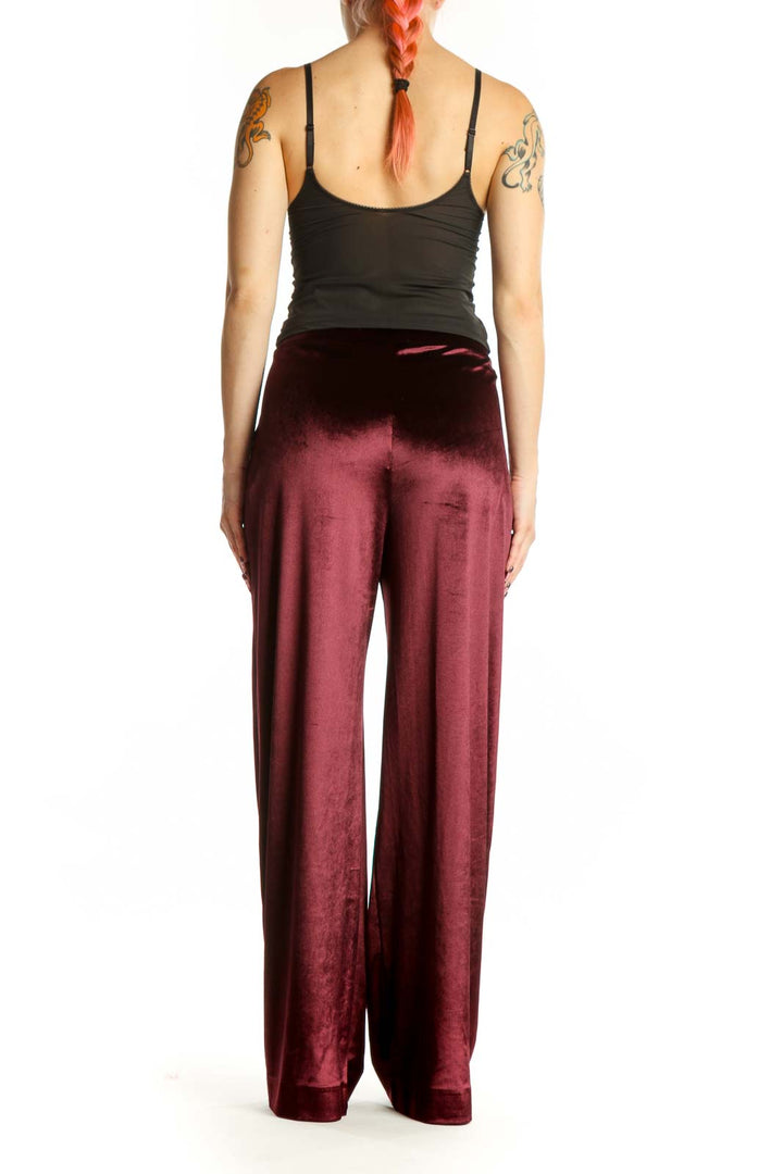 Back view of burgundy velvet wide-leg pants showing the elegant drape and full-length cut