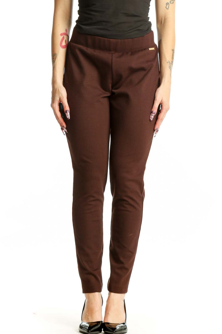 Front view of burgundy slim fit ankle pants with elastic waistband from MICHAEL Michael Kors