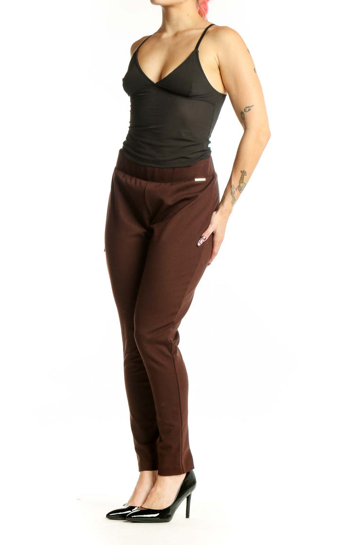 Front view of burgundy slim fit ankle pants with elastic waistband from MICHAEL Michael Kors