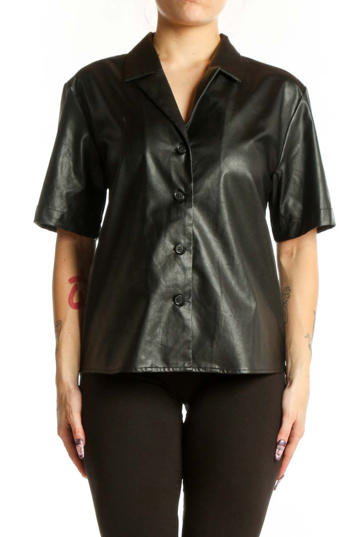 Black leather button-up short sleeve shirt with collared neckline, front view on model
