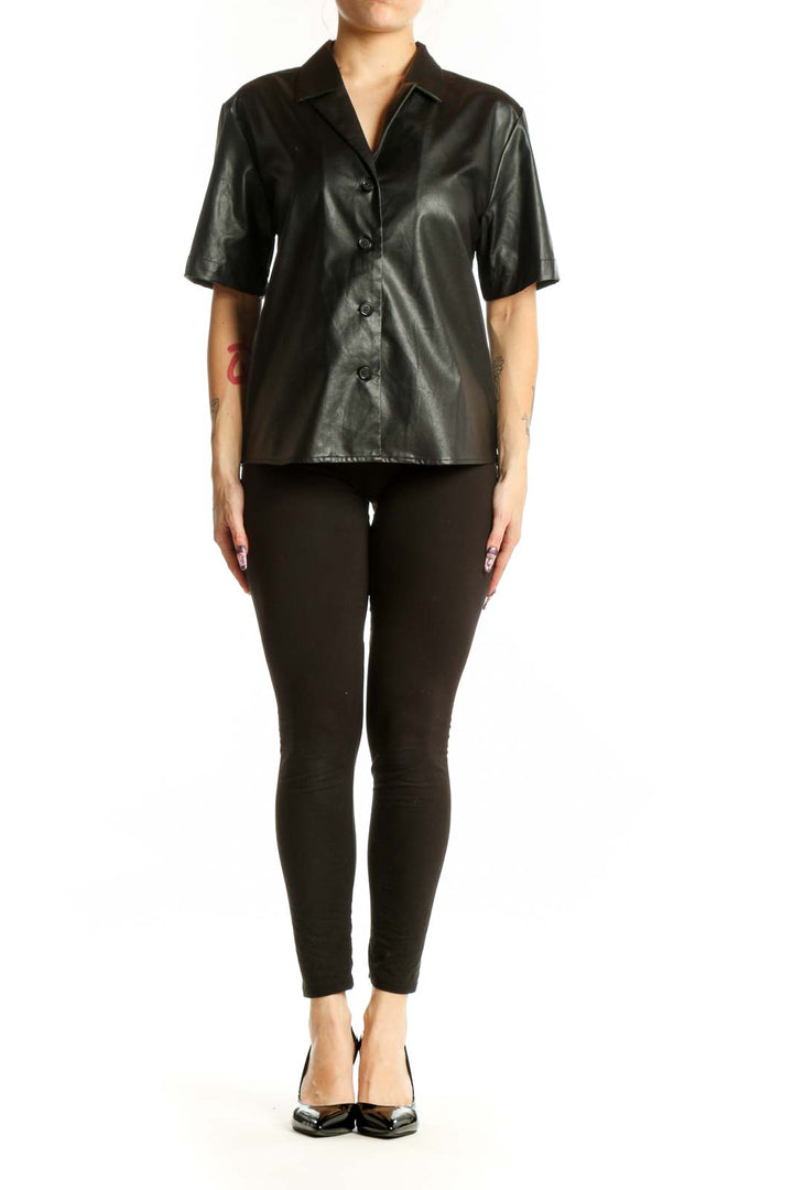 Black leather button-up short sleeve shirt with collared neckline, front view on model