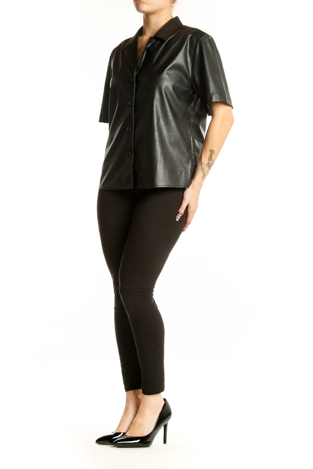 Black leather button-up short sleeve shirt with collared neckline, front view on model