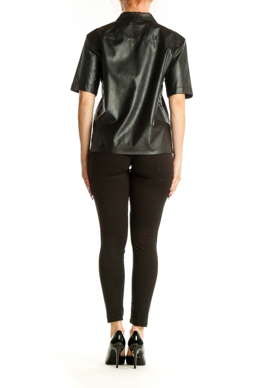 Black leather button-up short sleeve shirt, back view on model wearing black pants