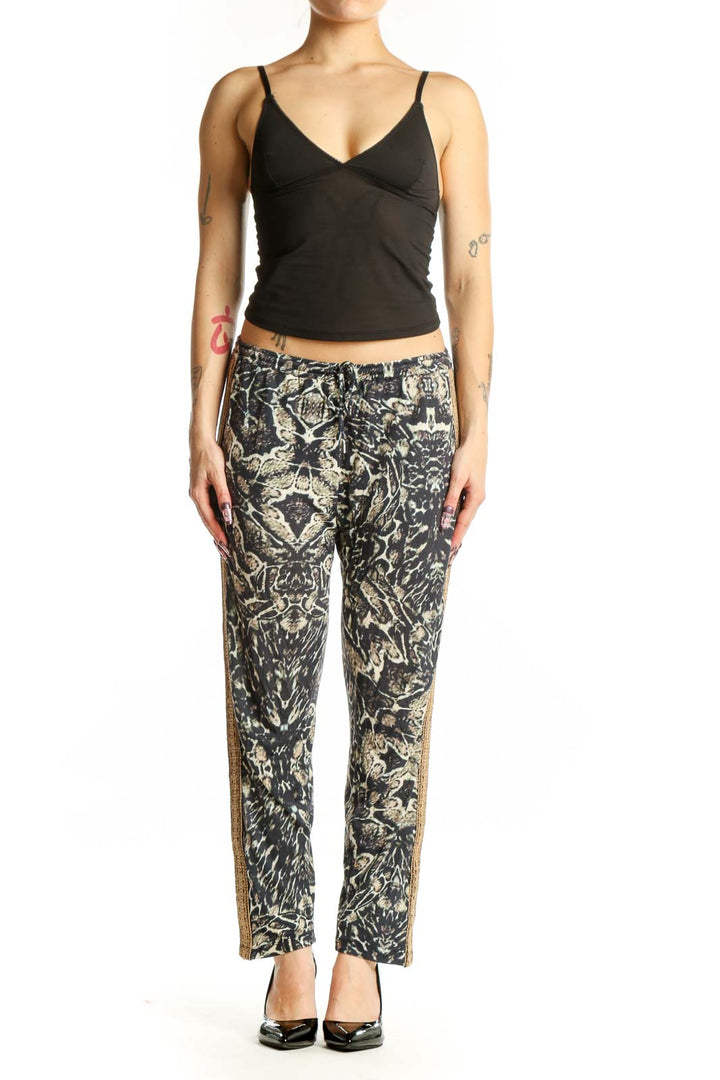 Black and cream floral print modal pants with gold metallic side trim, front view on model